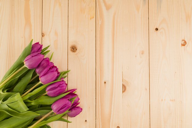 Top view flowers on wooden background with copy space