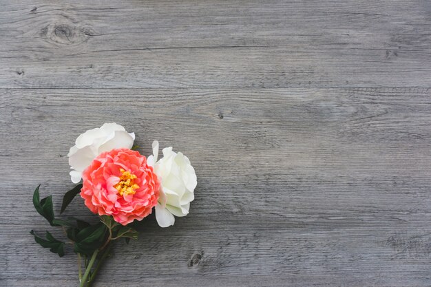 Top view of flowers on wooden surface