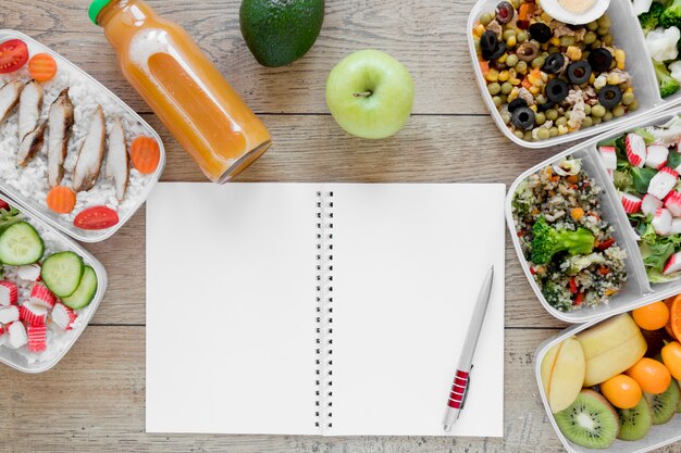Top view food arrangement with notebook