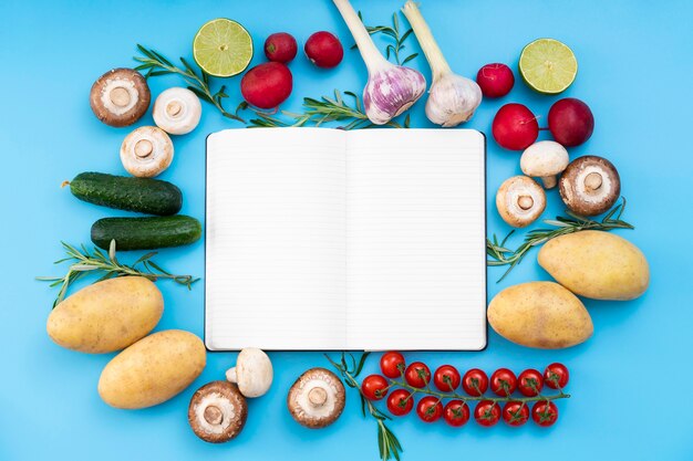 Top view food arrangement with notebook