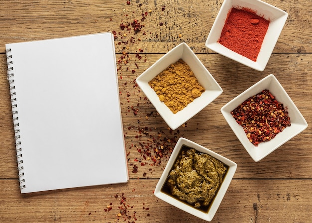 Top view of food ingredients with notebook and spices