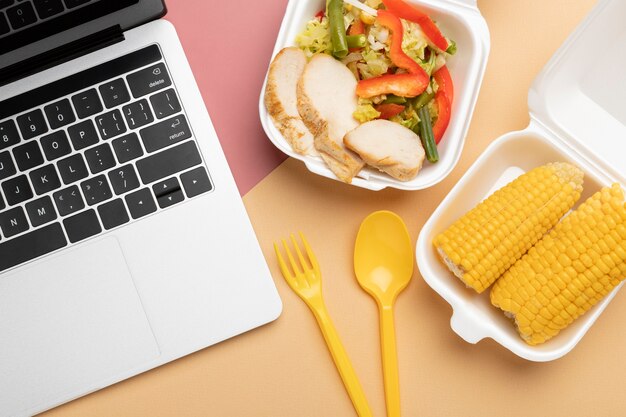 Top view food and laptop arrangement