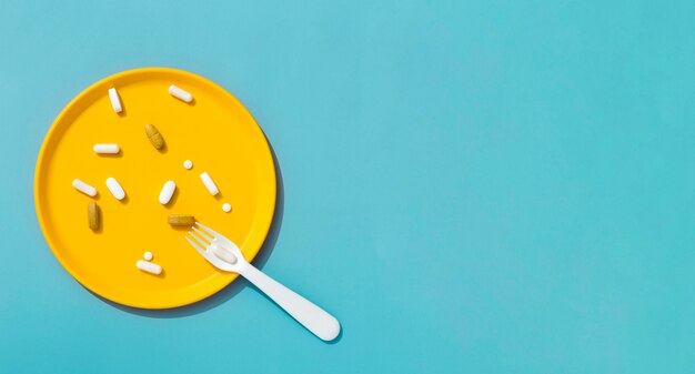 Top view of fork with tray of pills