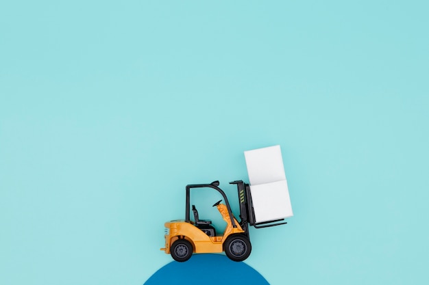 Free photo top view forklift carrying boxes