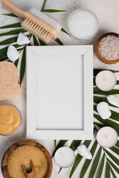 Top view frame surrounded by spa candles and brush