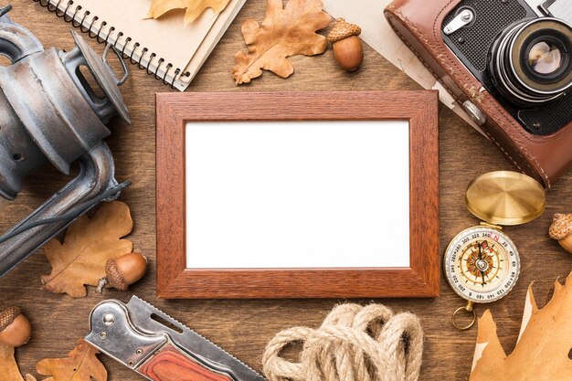 Top view of frame with autumn leaves and lantern