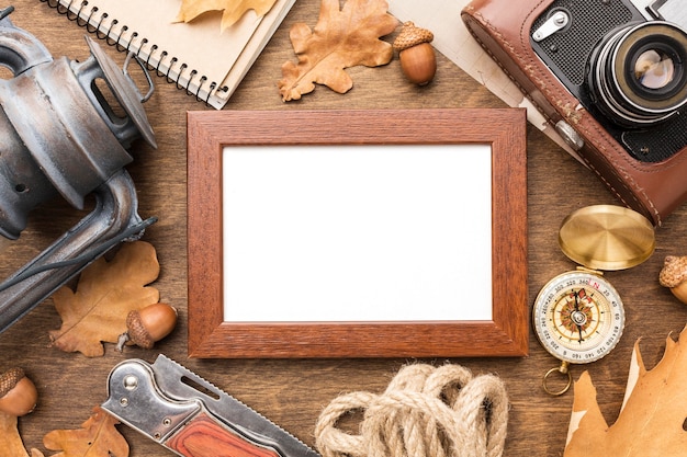 Top view of frame with autumn leaves and lantern