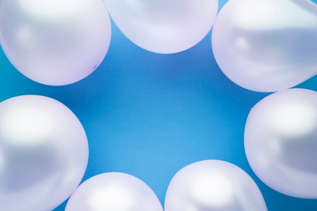 Top view frame with balloons and blue background