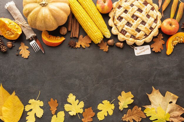 Top view frame with pie and corn on stucco background