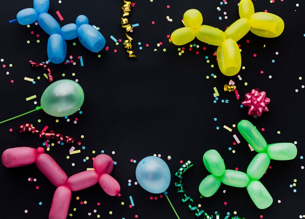 Top view frame with puppy balloons and confetti