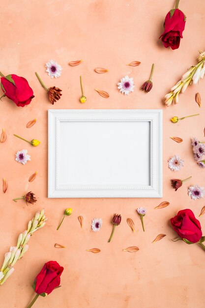 Top view of frame with roses and assortment of spring flowers