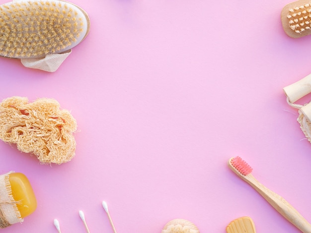 Top view frame with wooden items on pink background