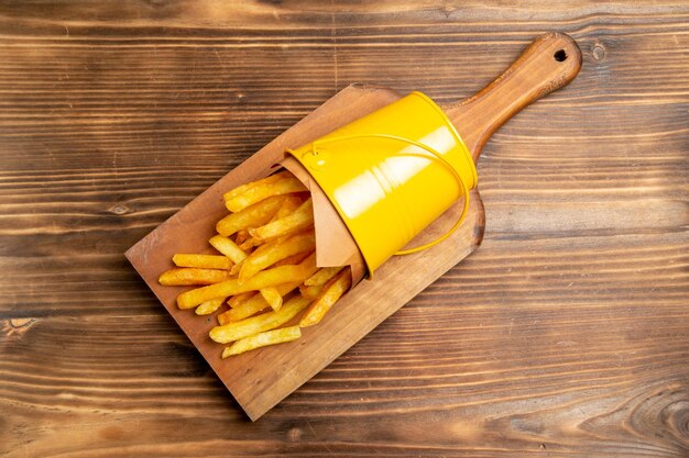 Top view of french fries on brown table