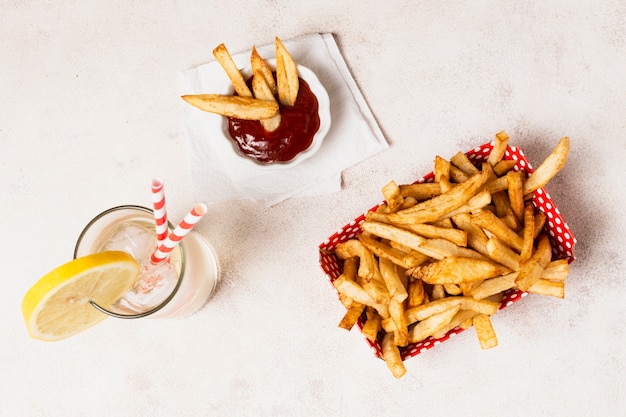 Top view of french fries with lemonade