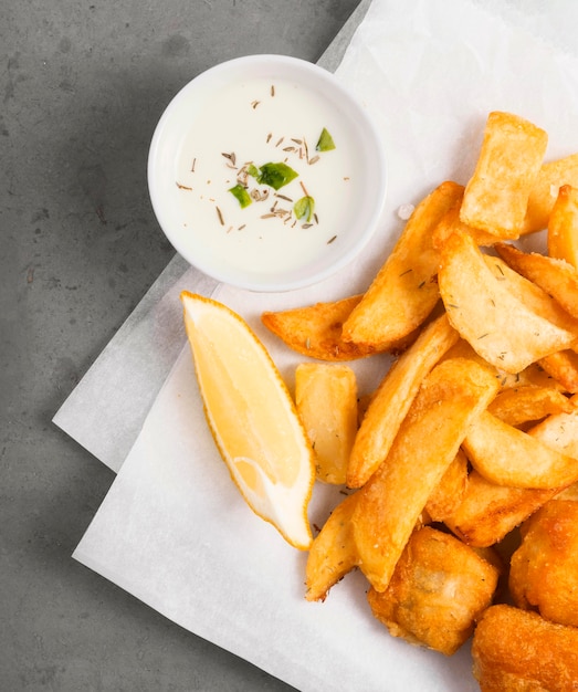 Top view of french fries with sauce in bowl