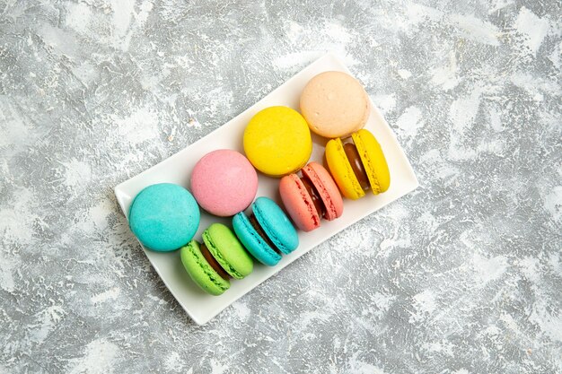 Top view french macarons ful cakes on the white surface