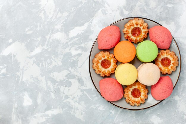 Top view french macarons with cookies on light white surface