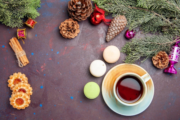 Free photo top view of french macarons with cookies and tea on black