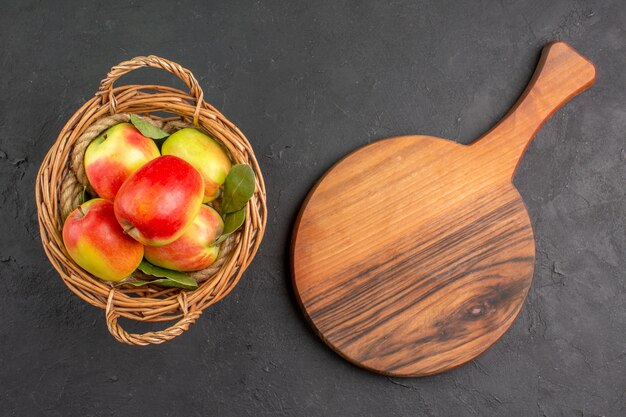 Top view fresh apples ripe fruits inside basket on grey desk  ripe fruit fresh