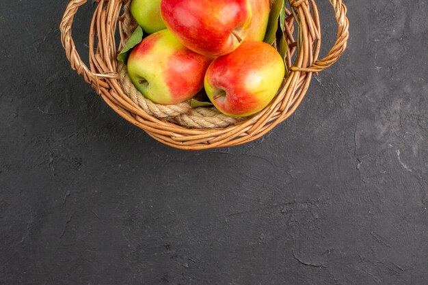 Top view fresh apples ripe fruits inside basket on grey table fruit fresh ripe