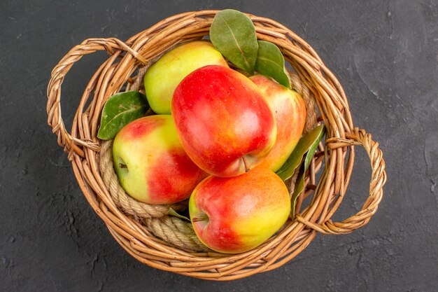 Top view fresh apples ripe fruits inside basket on grey table  ripe fruit fresh