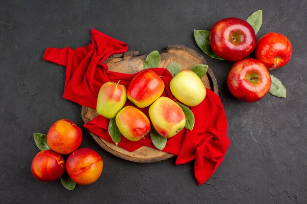 Top view fresh apples ripe fruits on red tissue and grey table fresh  ripe fruit