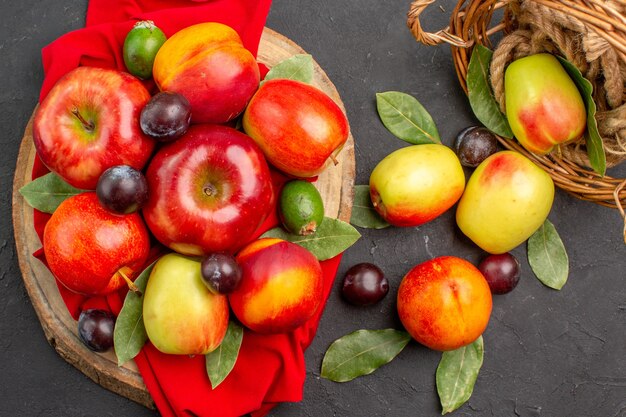 Top view fresh apples with peaches and plums on dark table juice tree mellow