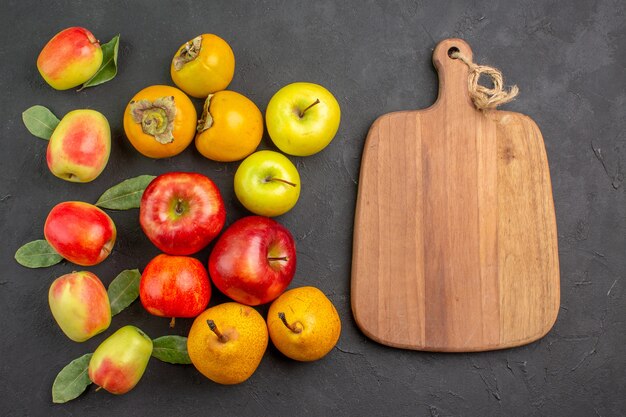 Top view fresh apples with persimmons and pears on dark table mellow fresh ripe tree