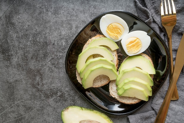 Top view fresh avocado slices with boiled eggs