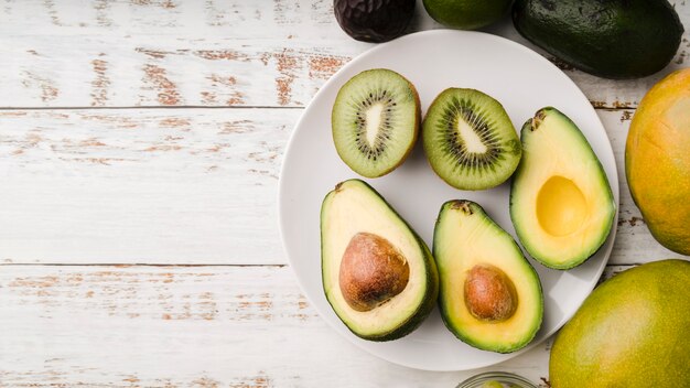 Top view fresh avocado with kiwi on a plate