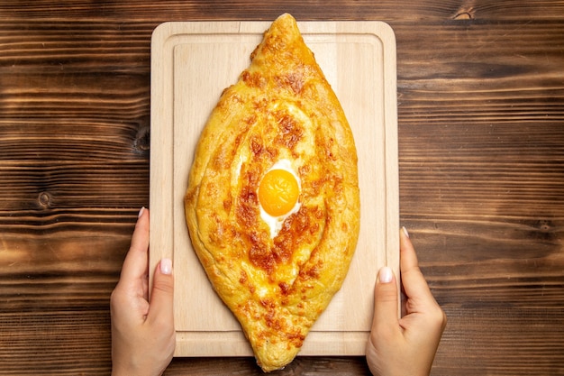 Top view fresh baked bread with cooked egg on a wooden desk bread dough meal bun food breakfast egg