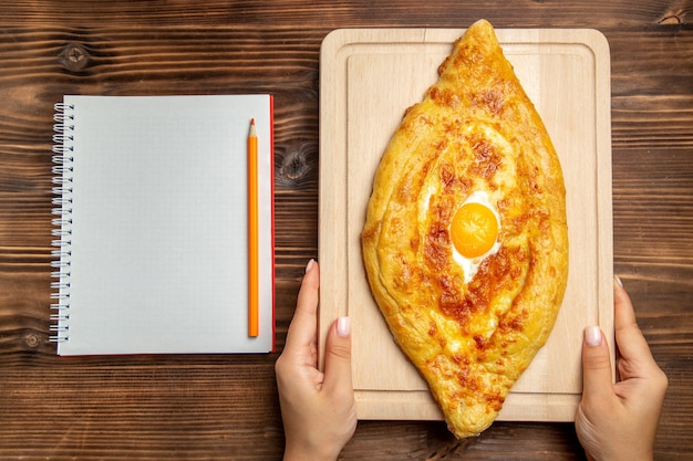 Top view fresh baked bread with cooked egg on wooden desk bread dough meal bun food breakfast eggs