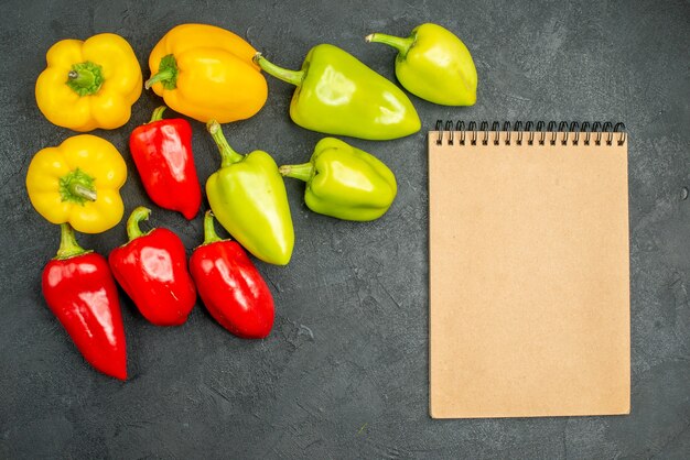 Top view fresh bell-peppers on a dark background salad food meal ripe photo color