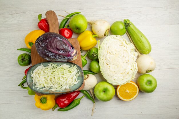 Top view fresh bell-peppers with apples cabbage on a white background ripe color  salad healthy life diet