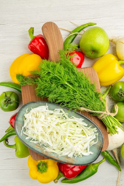 Top view fresh bell-peppers with apples and greens on white background ripe color salad healthy life diet