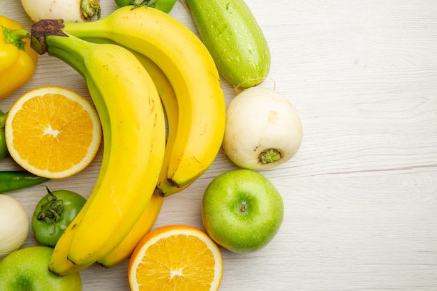 Top view fresh bell-peppers with bananas and apples on white background  salad healthy life ripe color diet