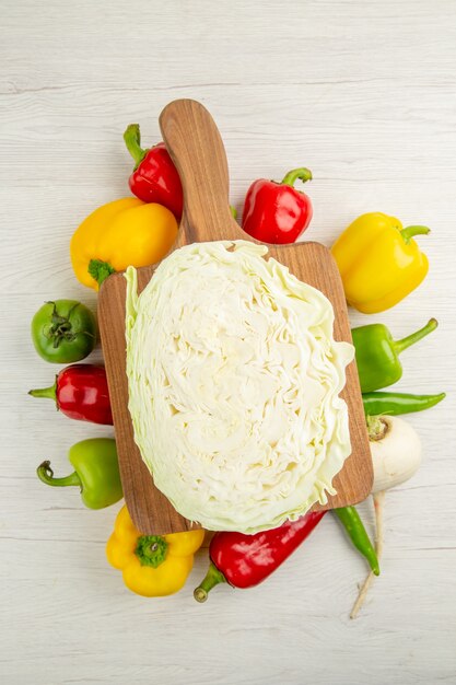 Top view fresh bell-peppers with cabbage on a white background diet salad color healthy life photo ripe