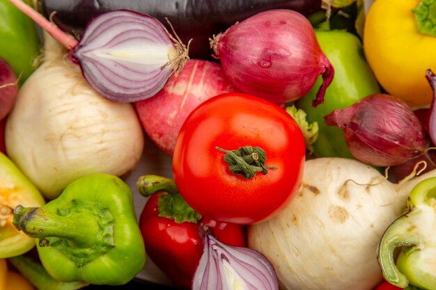 Top view fresh bell-peppers with radish buns and onions on white table