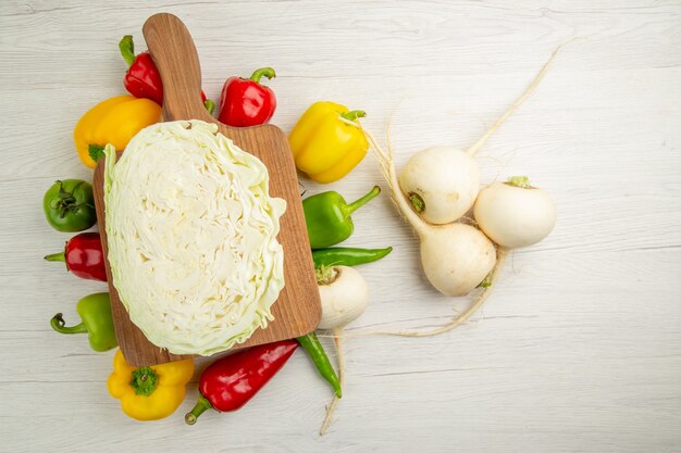 Top view fresh bell-peppers with radish and cabbage on white background diet salad color healthy life photo ripe