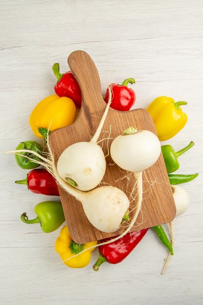 Top view fresh bell-peppers with radish on a white background salad color healthy life diet photo ripe