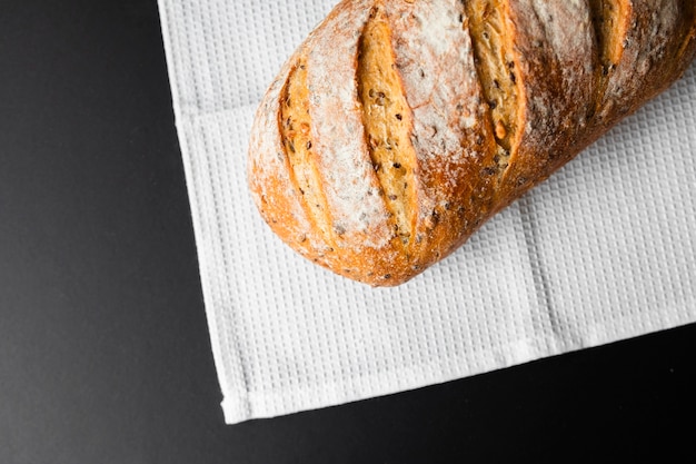 Top view fresh bread on black background and cloth