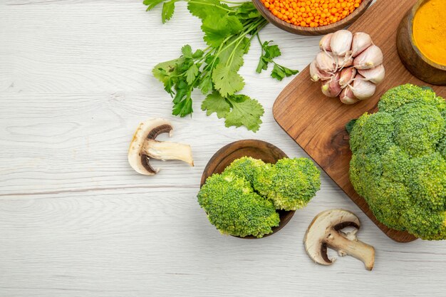 Top view fresh broccoli garlic turmeric on wood serving board