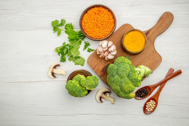 Top view fresh broccoli garlic turmeric on wood serving board