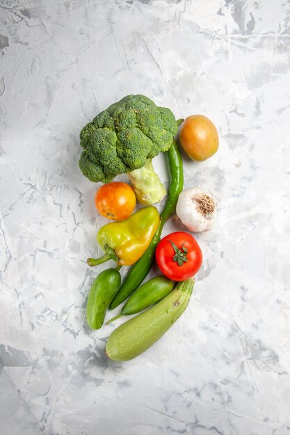 Top view fresh broccoli with vegetables on white table salad ripe health diet