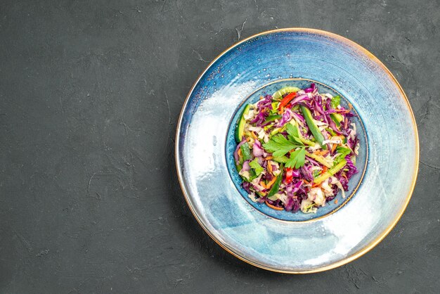 Top view fresh cabbage salad inside plate on dark background