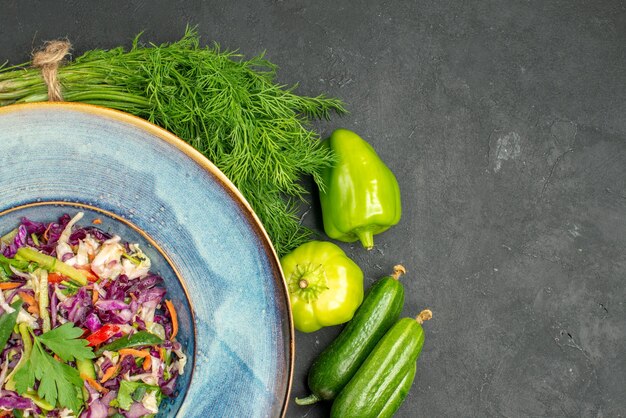 Top view fresh cabbage salad with greens and vegetables on dark background