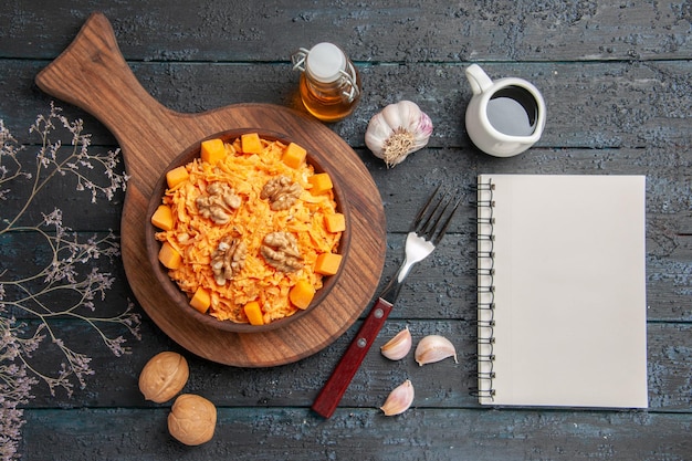 Top view fresh carrot salad grated salad with walnuts on a dark desk diet color nut health salad