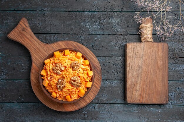 Top view fresh carrot salad grated salad with walnuts on dark desk diet color nut health salad