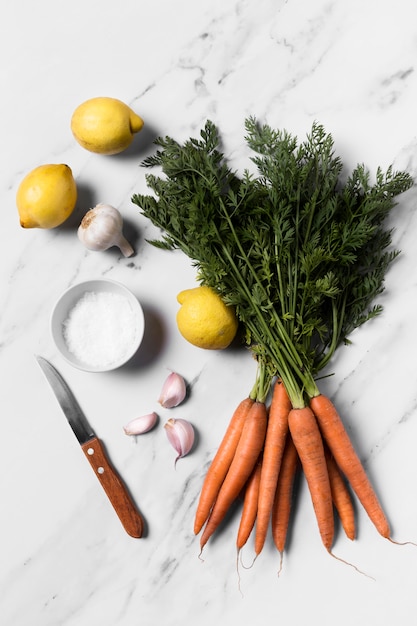 Top view fresh carrots on marble table