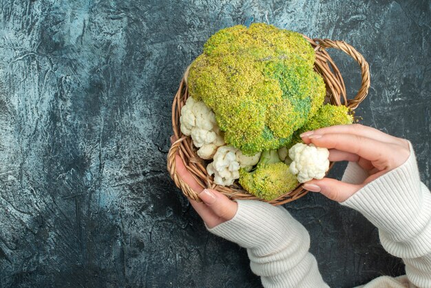 Top view fresh cauliflower inside basket on light-grey table